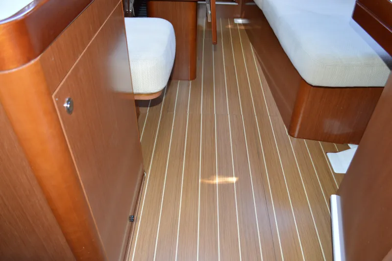 Slide: The Image of Interior of 2012 Beneteau Oceanis 34 yacht with wooden flooring and seating. - 41