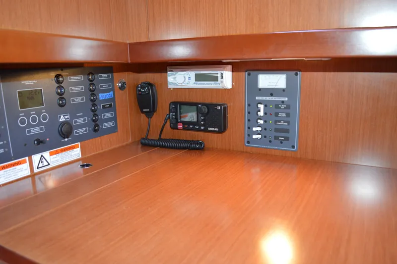 Slide: The Image of Control panel of 2012 Beneteau Oceanis 34 sailboat with navigation and communication equipment. - 42