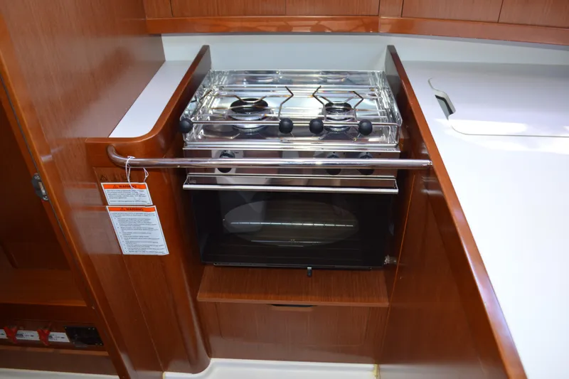 Slide: The Image of Galley kitchen in 2012 Beneteau Oceanis 34 sailboat with stove and oven. - 48