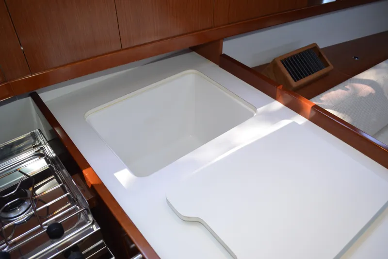Slide: The Image of Galley area of 2012 Beneteau Oceanis 34 yacht with sink and stove. - 49