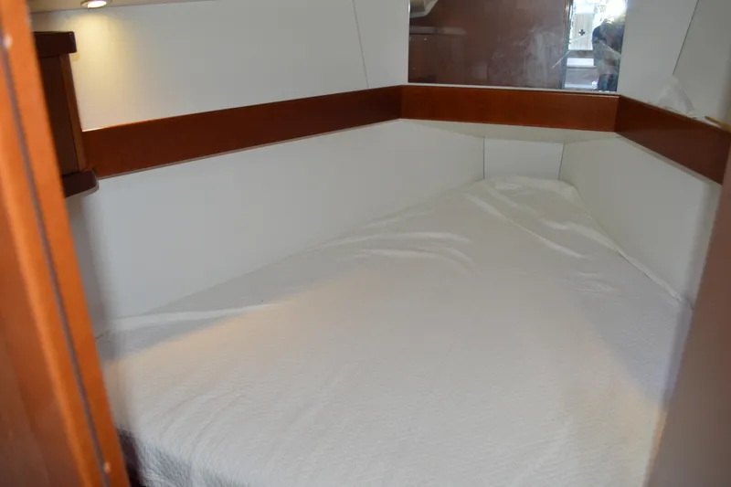 Slide: The Image of Cozy cabin interior of 2012 Beneteau Oceanis 34 sailboat with white bedding. - 50