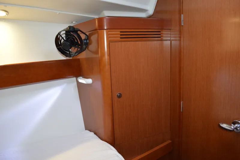 Slide: The Image of Interior cabin of 2012 Beneteau Oceanis 34 yacht with wooden cabinetry and fan. - 51