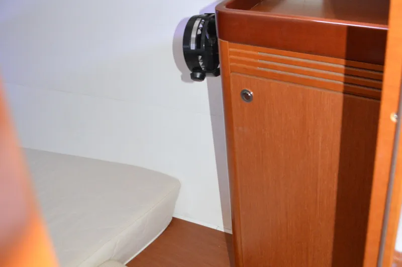 Slide: The Image of Interior cabin view of a 2012 Beneteau Oceanis 34 sailboat, featuring wooden cabinetry. - 55