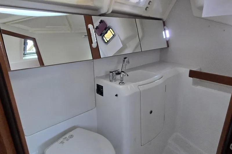 Slide: The Image of Beneteau Oceanis 34 2012 yacht bathroom with mirror, sink, and toilet. - 56