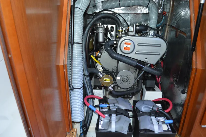 Slide: The Image of Engine compartment of 2012 Beneteau Oceanis 34 sailboat, featuring dual batteries and ventilation hoses. - 60