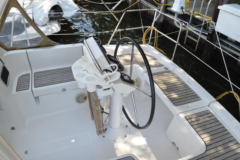 Slide: The Image of Cockpit of 2012 Beneteau Oceanis 34 sailboat with steering wheel and seating. - 9