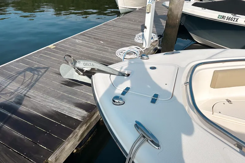 Slide: The Image of 2016 Pursuit C 238 Center Console boat docked with visible anchor and deck. - 11