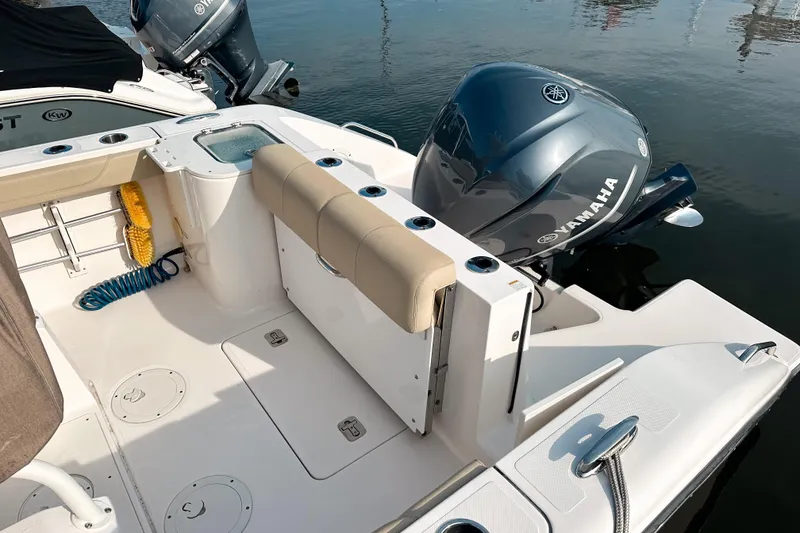 Slide: The Image of 2016 Pursuit C 238 Center Console boat with Yamaha outboard engine, docked on calm water. - 7