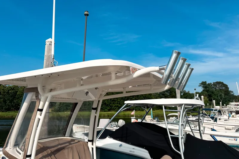 Slide: The Image of 2016 Pursuit C 238 Center Console boat docked under clear blue sky. - 9