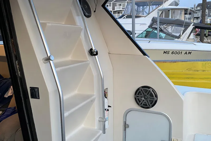 Slide: The Image of Interior view of 1989 Mainship Mediterranean Convertible boat with stairs and speaker. - 11