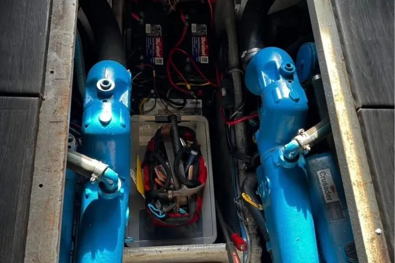 Slide: The Image of Engine compartment of a 1989 Mainship Mediterranean Convertible with blue components and wiring. - 26