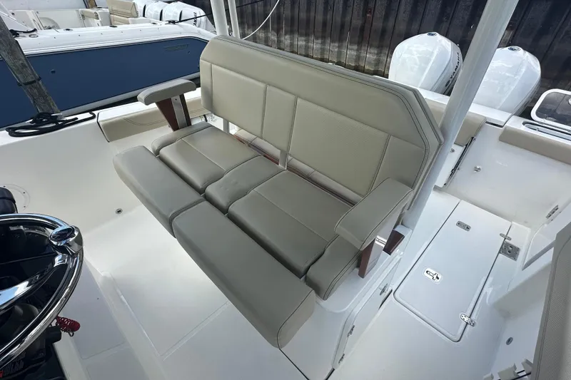 Slide: The Image of 2021 Pursuit S 288 Sport boat interior with beige seating and modern design. - 13