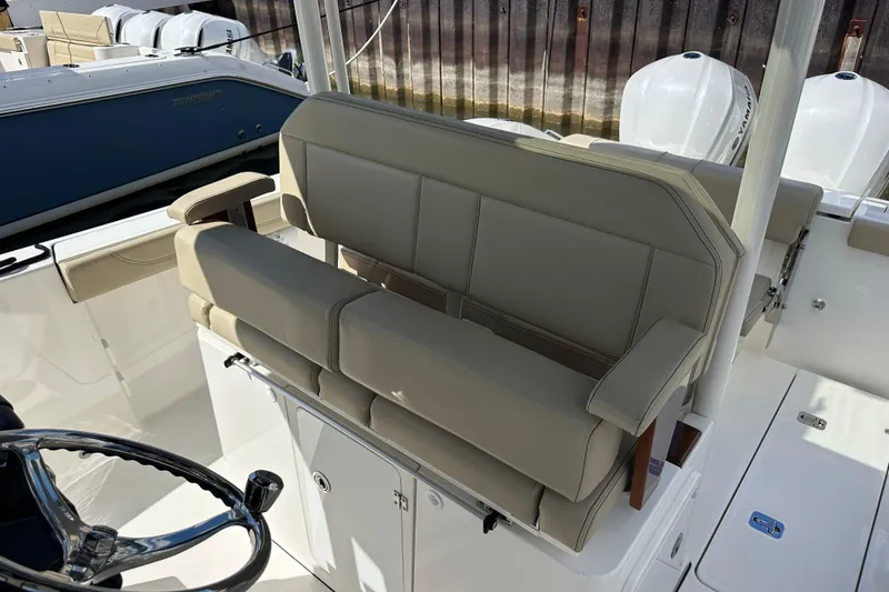 Slide: The Image of 2021 Pursuit S 288 Sport boat interior with beige seating and steering wheel. - 14