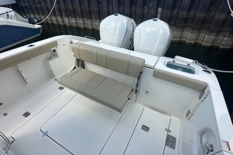 Slide: The Image of 2021 Pursuit S 288 Sport boat interior with seating and twin Yamaha engines. - 17