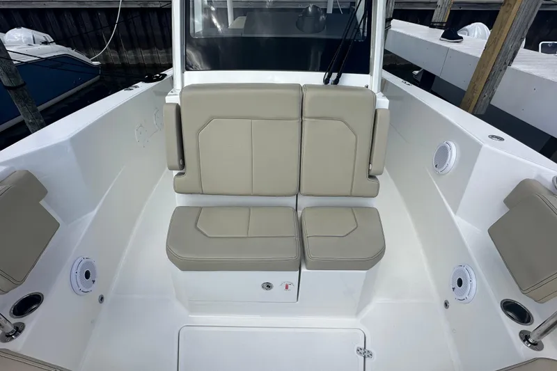 Slide: The Image of 2021 Pursuit S 288 Sport boat interior with beige seating and white deck. - 7