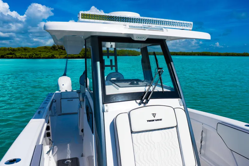 Slide: The Image of 2025 Twin Vee 260 GFX2 CC boat on turquoise water under clear blue sky. - 10