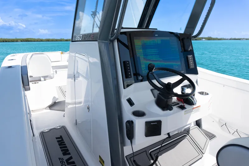 Slide: The Image of 2025 Twin Vee 260 GFX2 CC boat interior with steering console and navigation display. - 16