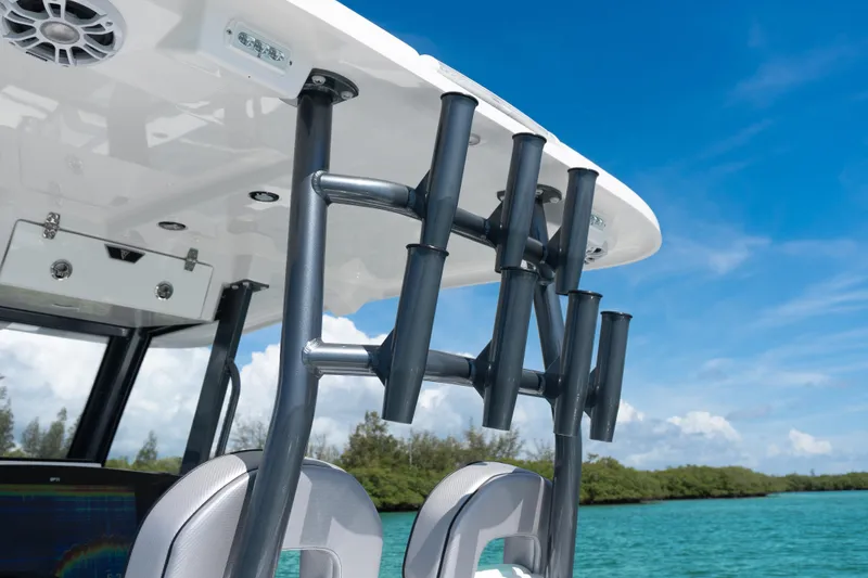 Slide: The Image of 2025 Twin Vee 260 GFX2 CC boat with rod holders, under clear blue sky. - 20