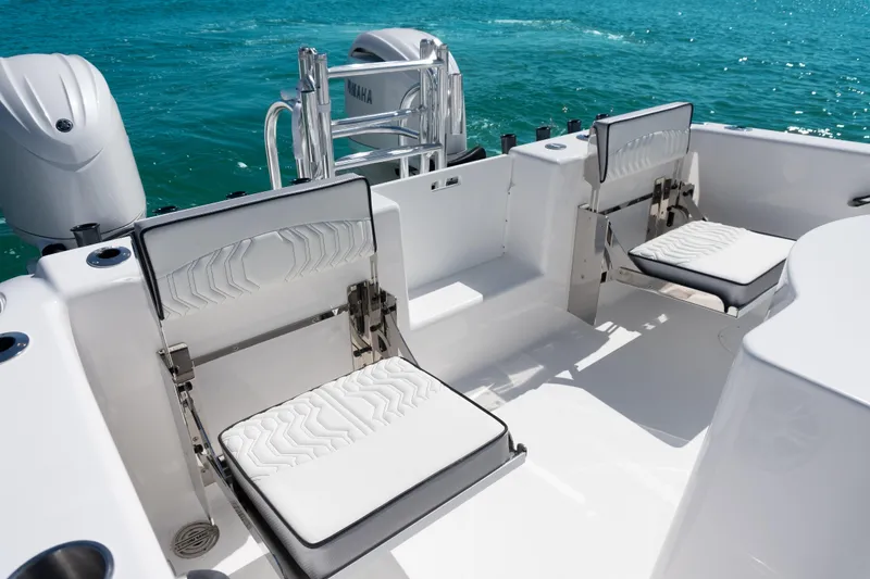 Slide: The Image of 2025 Twin Vee 260 GFX2 CC boat interior with foldable seats and Yamaha engines. - 22