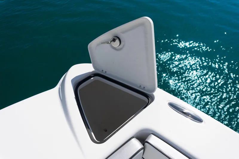 Slide: The Image of 2025 Twin Vee 260 GFX2 CC boat hatch open on sparkling blue water. - 28
