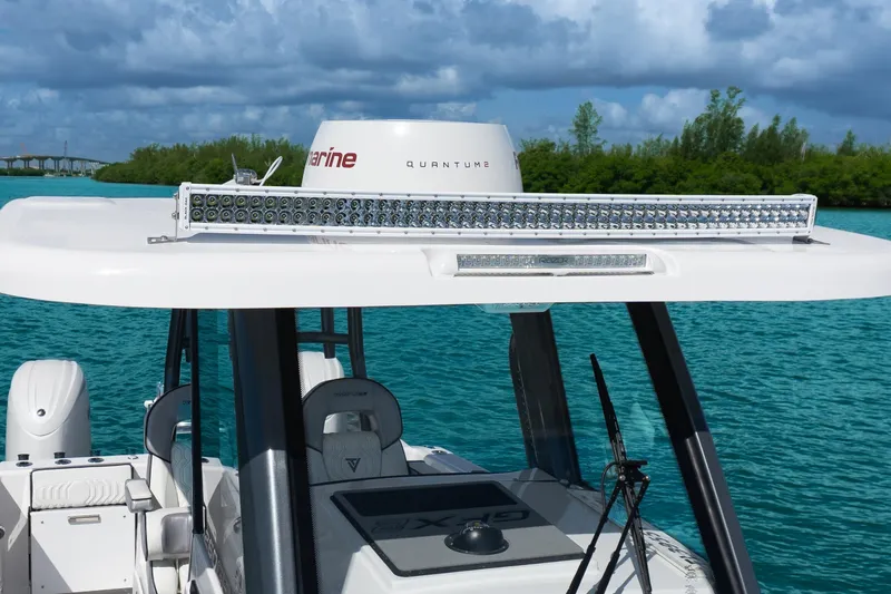 Slide: The Image of 2025 Twin Vee 260 GFX2 CC boat with advanced radar and lighting system on turquoise water. - 30
