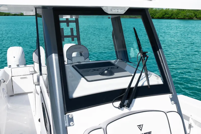 Slide: The Image of 2025 Twin Vee 260 GFX2 CC boat on turquoise water, showcasing helm and seating. - 31