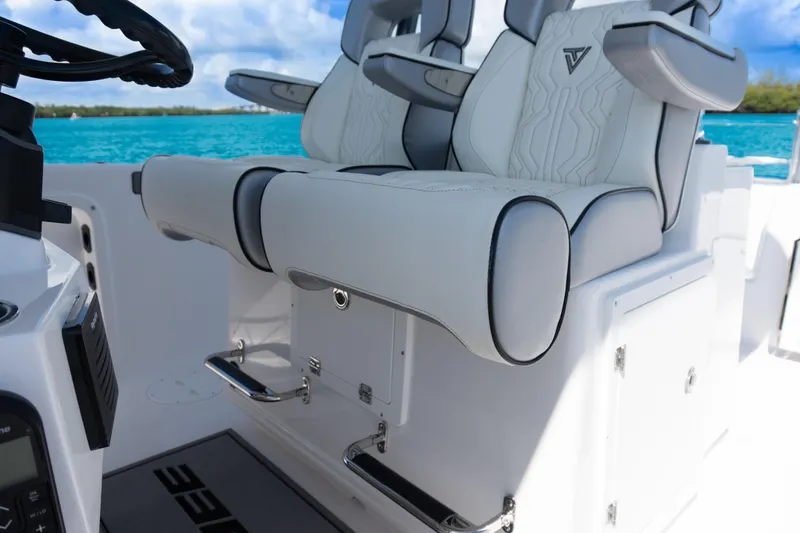 Slide: The Image of 2025 Twin Vee 260 GFX2 CC boat interior with luxurious seating and ocean backdrop. - 37