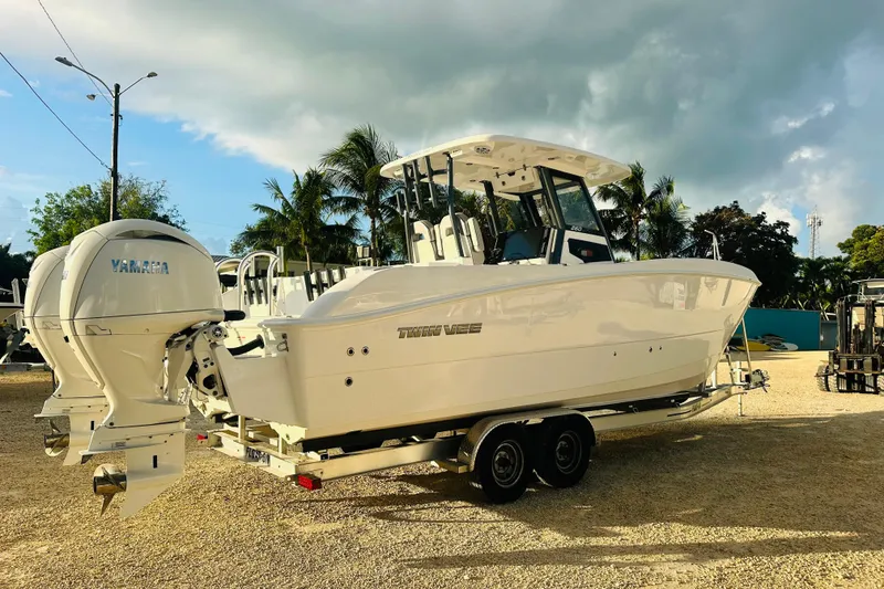 Slide: The Image of 2025 Twin Vee 260 GFX2 CC boat with Yamaha engines on a trailer, parked outdoors. - 5