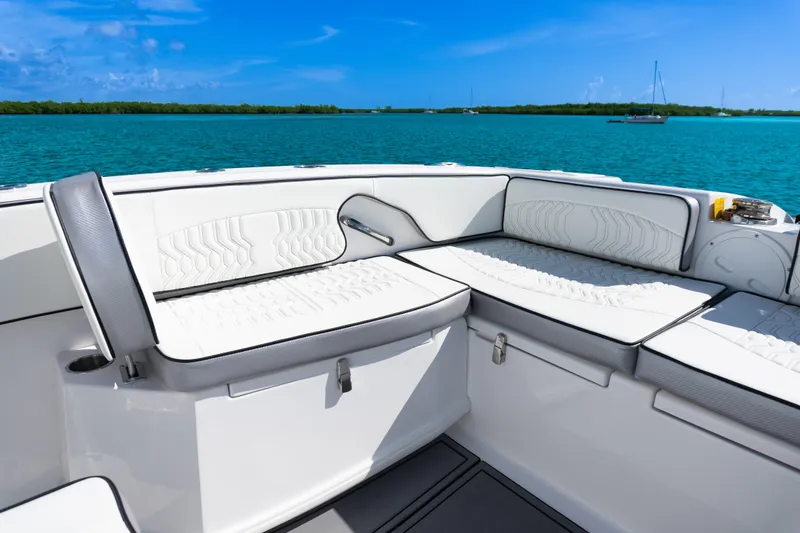 Slide: The Image of 2025 Twin Vee 260 GFX2 CC boat interior with white cushioned seating, ocean view. - 7