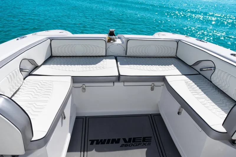 Slide: The Image of 2025 Twin Vee 260 GFX2 CC boat interior with white seating, ocean backdrop. - 8