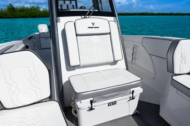 Slide: The Image of 2025 Twin Vee 260 GFX2 CC boat interior with white cushioned seating and Yeti cooler. - 9