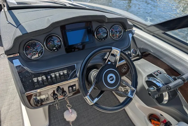Slide: The Image of 2016 Chaparral 307 SSX boat dashboard with steering wheel and control panel. - 13