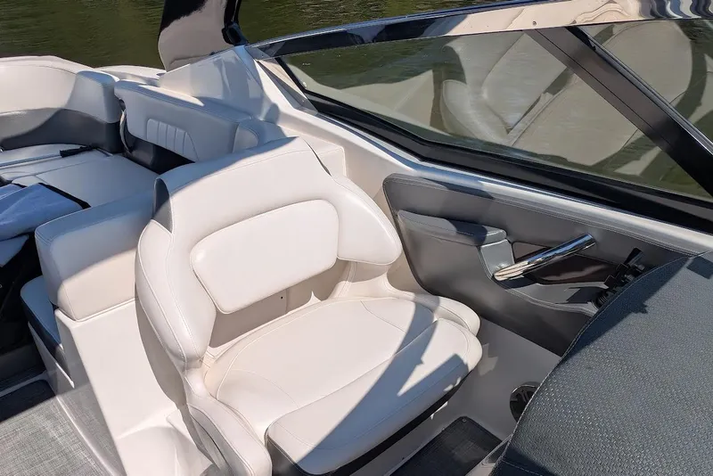 Slide: The Image of 2016 Chaparral 307 SSX boat interior with white seating and sleek design. - 15