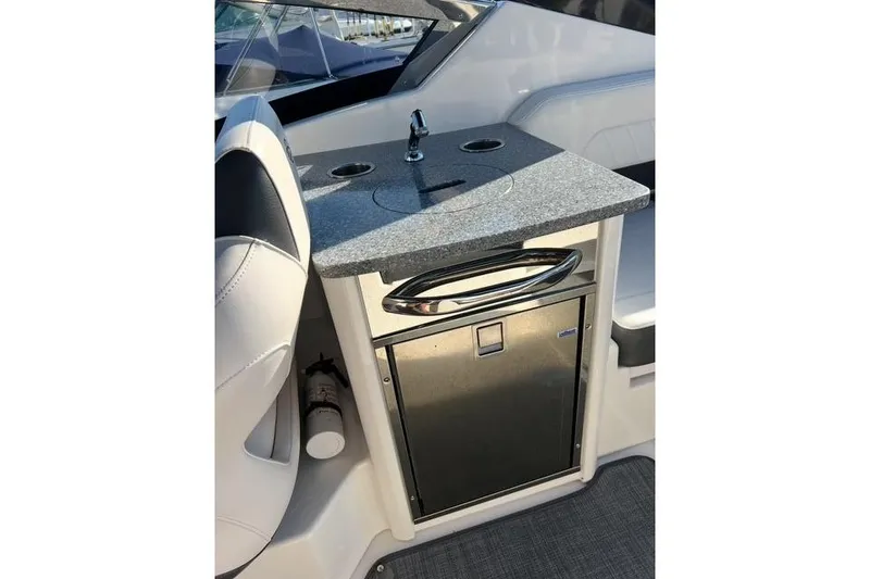 Slide: The Image of 2016 Chaparral 307 SSX boat interior with sink and mini fridge. - 17