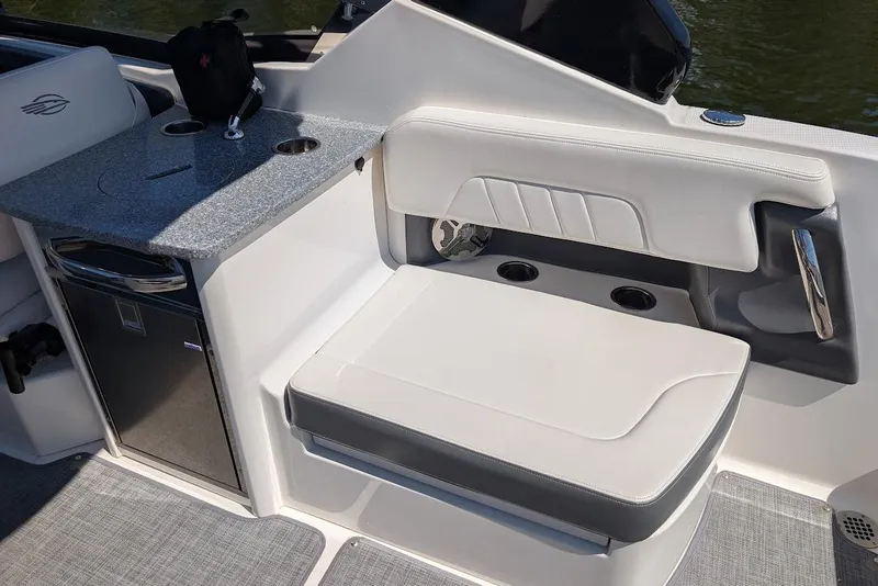 Slide: The Image of 2016 Chaparral 307 SSX boat interior with seating and kitchenette area. - 18
