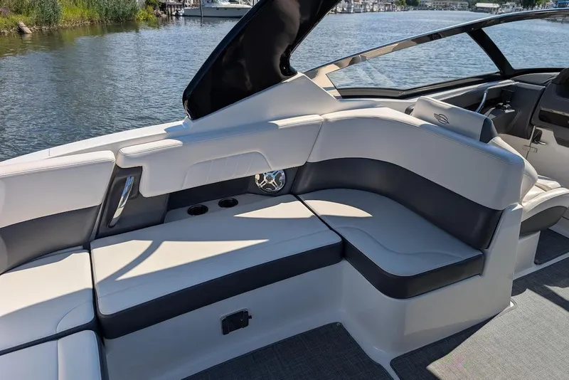 Slide: The Image of 2016 Chaparral 307 SSX boat interior with sleek seating and waterfront view. - 21