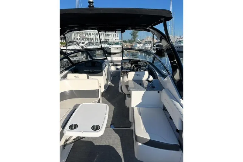 Slide: The Image of 2016 Chaparral 307 SSX boat interior with seating and helm, docked at marina. - 22
