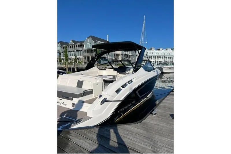 Slide: The Image of 2016 Chaparral 307 SSX boat docked at marina with clear blue sky. - 24