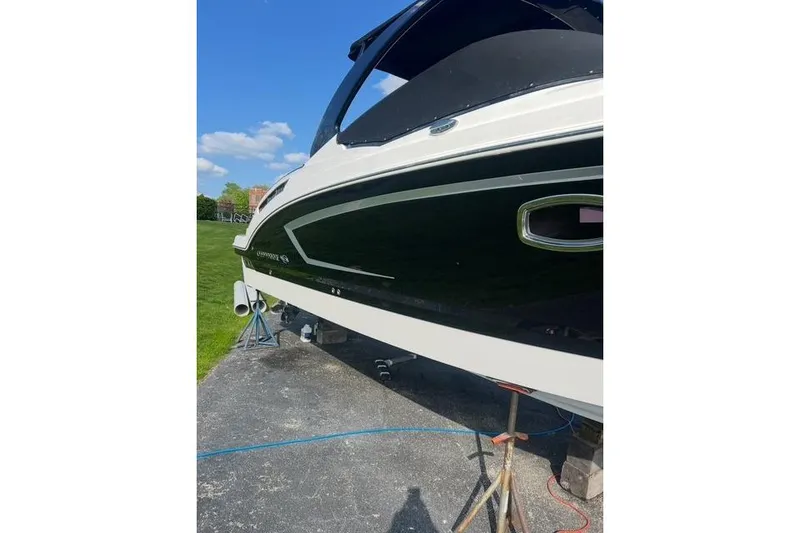 Slide: The Image of 2016 Chaparral 307 SSX boat on stands, sunny day, grassy background. - 32