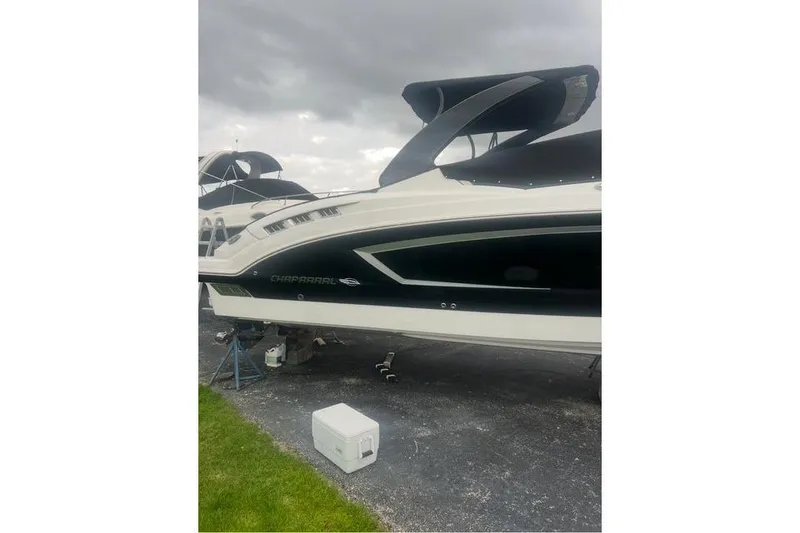 Slide: The Image of 2016 Chaparral 307 SSX boat on display, featuring sleek design and black accents. - 34