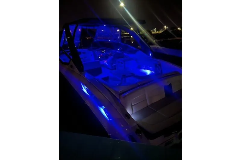 Slide: The Image of 2016 Chaparral 307 SSX boat with blue LED lights at night. - 4