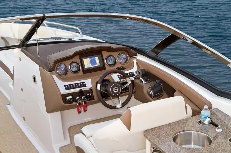 Slide: The Image of Manufacturer Provided Image: 2016 Chaparral 307 SSX boat dashboard with steering wheel and navigation system. - 40