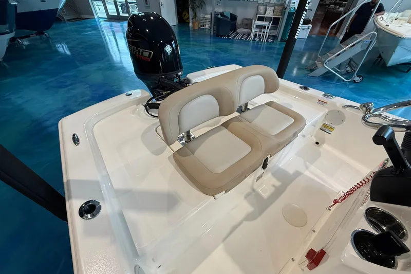 Slide: The Image of 2026 Scout 177 XSS boat interior with dual beige seats and outboard motor. - 10