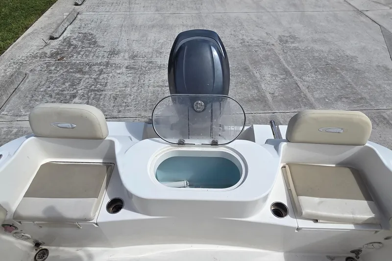 Slide: The Image of 2014 Cobia 217 Center Console boat with seating and storage compartments. - 10