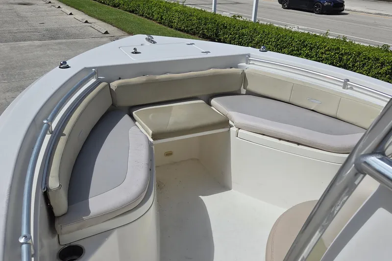 Slide: The Image of 2014 Cobia 217 Center Console boat with cushioned seating area. - 12