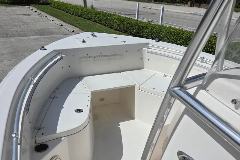 Slide: The Image of 2014 Cobia 217 Center Console boat interior with seating and storage compartments. - 13