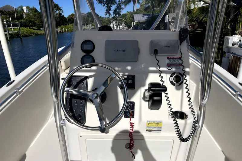 Slide: The Image of 2014 Cobia 217 Center Console boat dashboard with steering wheel and controls. - 4