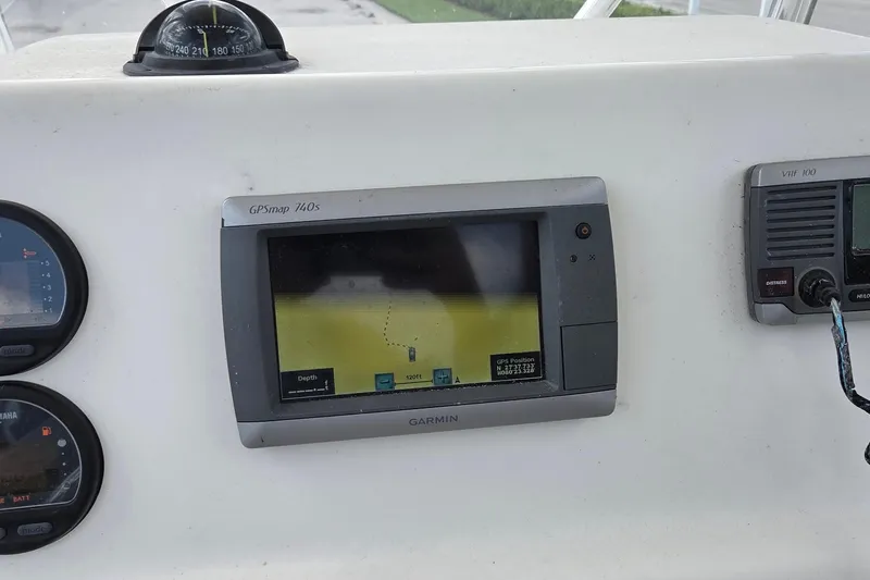 Slide: The Image of 2014 Cobia 217 Center Console dashboard with Garmin GPSmap 740s and VHF 100 radio. - 6