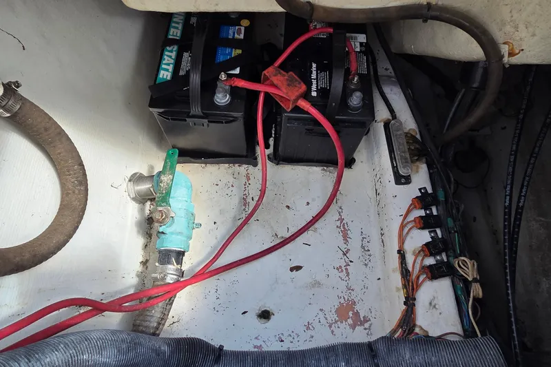 Slide: The Image of 2014 Cobia 217 Center Console boat battery compartment with wiring and connections. - 8