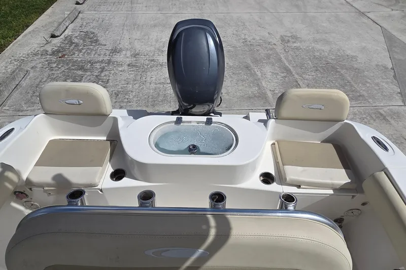 Slide: The Image of 2014 Cobia 217 Center Console boat interior with seating and motor. - 9